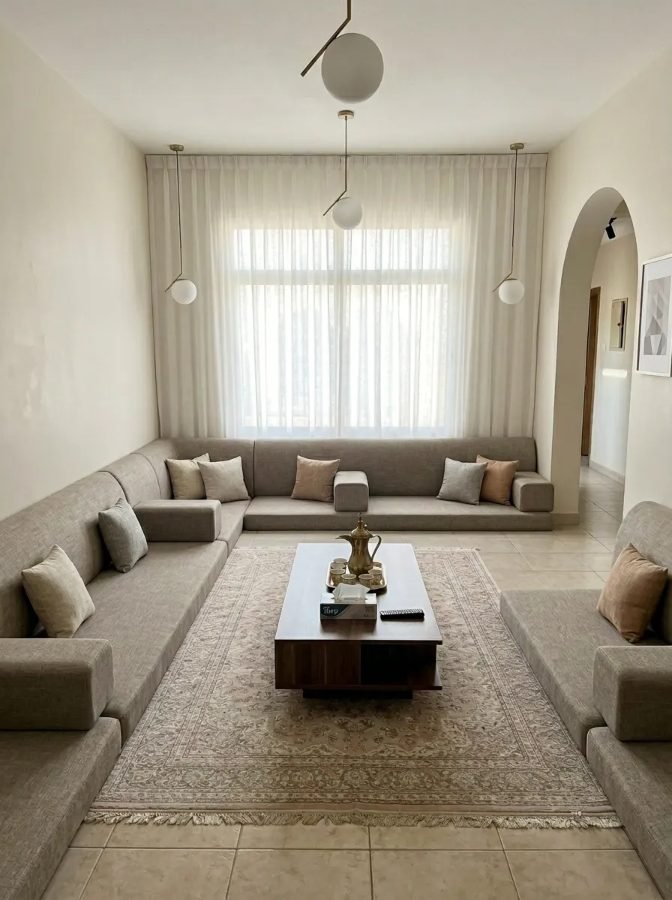 Stone linen bench, sheer curtains, warm pendants