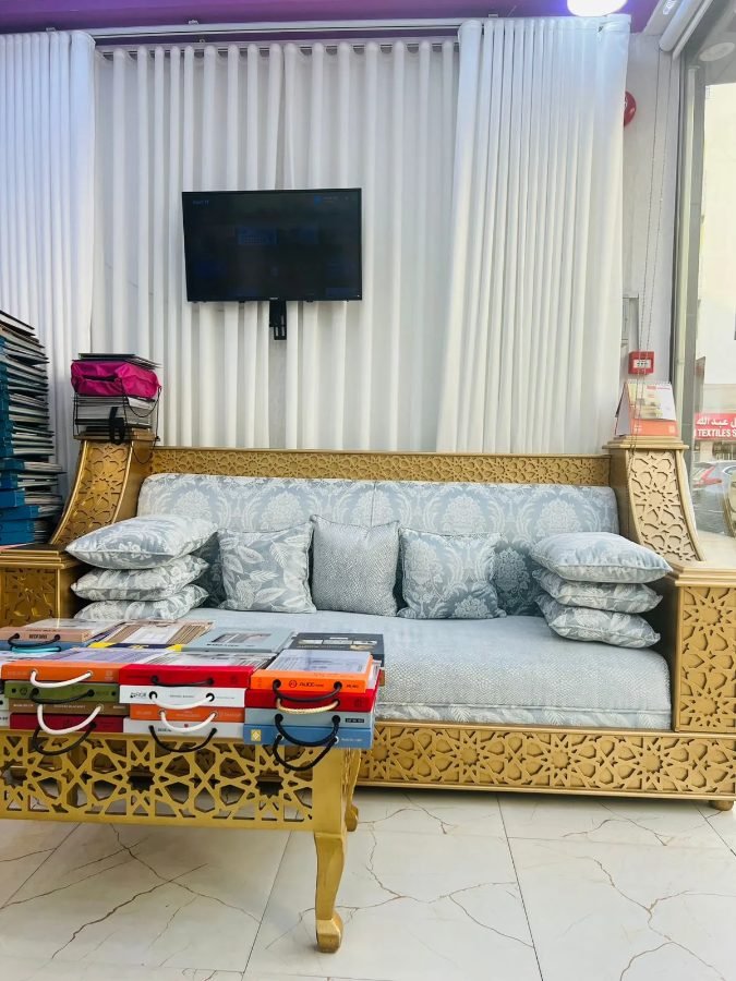 Showroom — gold majlis bench and sample books